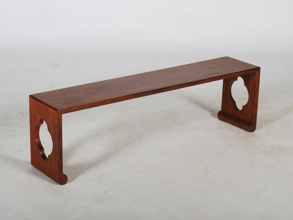 A Chinese dark wood bench, 20th century, of plain rectangular form with pierced quartrefoil