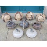 A pair of granite curling stones, four leather mounted curling stone baskets and three leather