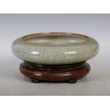 A Chinese porcelain crackle-glazed celadon ground bowl, late Qing Dynasty, of shallow circular form,