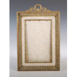 An Edwardian gilt metal photograph frame of Neo-Classical style, with pierced foliate surmount and