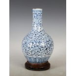 A Chinese porcelain blue and white bottle vase, Qing Dynasty, decorated with scrolling foliage and