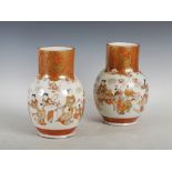 A pair of Japanese Kutani porcelain vases, Meiji Period, decorated with a continuous frieze of