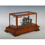 A Victorian oak and lacquered brass barograph, enclosed within a detachable bevelled glass case,