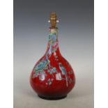 A Chinese porcelain sang-de-boeuf glazed bottle vase, Qing Dynasty, decorated in coloured enamels