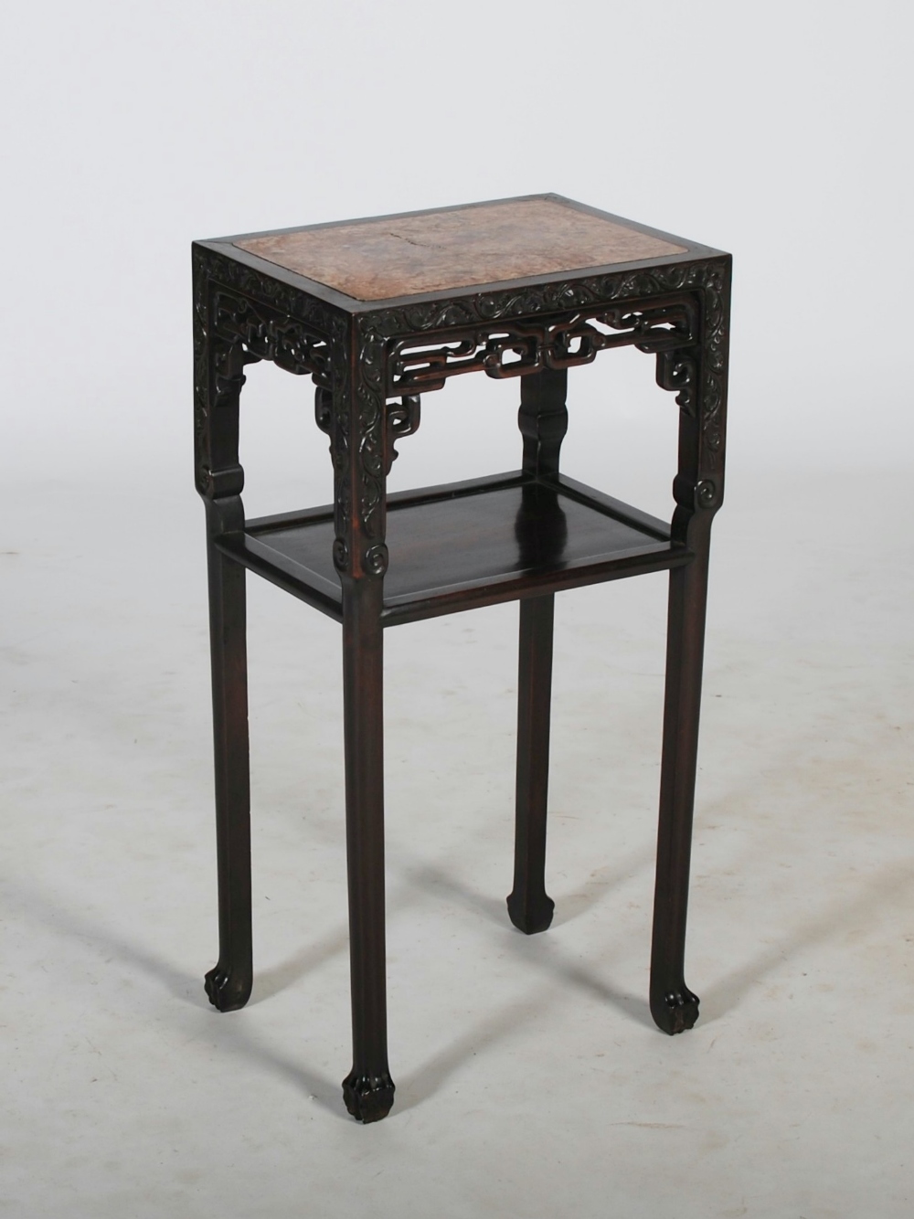 A Chinese dark wood jardiniere stand, Qing Dynasty, the rectangular top with a mottled red and white