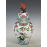 A Chinese famille rose jar and cover, decorated with rockwork, peony and long tailed birds, the
