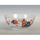 A Chinese porcelain Imari punch bowl, Qing Dynasty, decorated with a fenced garden of rockwork and