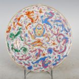 A Chinese porcelain famille rose dragon plate, Qing Dynasty, decorated with six dragons and
