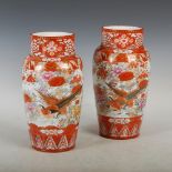 A near pair of Japanese Kutani vases, Meiji Period, decorated with pairs of birds in a garden of