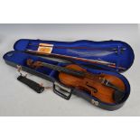 An antique violin and two bows in fitted case, apparently unmarked, full size