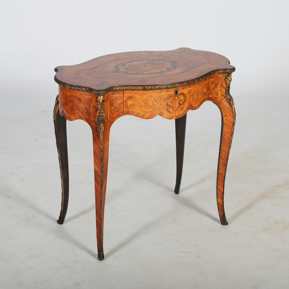 A late 19th century rosewood, marquetry and gilt metal mounted table, the shaped oval top