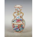 A Chinese porcelain Canton famille rose twin handled vase, Qing Dynasty, decorated with panels of