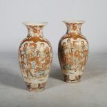 A large pair of Japanese Satsuma pottery vases, Meiji Period, decorated with panels of Lohan on a