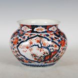 A late 19th/ early 20th century Japanese Imari jardiniere, decorated with two shaped panels of