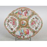 A Chinese porcelain Canton famille rose oval-shaped dish, decorated with panels of figures divided