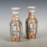 A pair of Chinese porcelain Canton famille rose vases, Qing Dynasty, decorated with panels of
