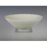 A Chinese porcelain white glazed bowl, of tapered conical form with incised flower decoration,