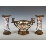 A 19th century Japanese ormolu mounted Imari garniture, comprising a bowl decorated with peony and