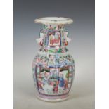 A Chinese porcelain famille rose vase, Qing Dynasty, decorated with panels of Court figures, the