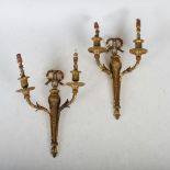 A pair of late 19th/ early 20th century ormolu two light wall sconces in the Neo-Classical style,