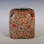 A Japanese pottery jar/ jardiniere, of rectangular form with a circular rim and six smaller circular