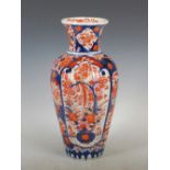 A Japanese Imari vase, of lobbed form decorated with panels of urns issuing flowers and foliage,