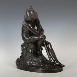 A late 19th century bronze figure of a shepherd, cast sitting on a rocky outcrop, wearing a straw