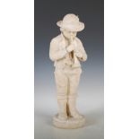 A late 19th/ early 20th century alabaster figure of a boy, carved standing playing the horn, on a