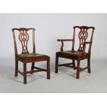 A set of eight early 20th century mahogany dining chairs in the George III style, the shaped top