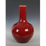 A large Chinese porcelain sang-de-boeuf glazed bottle vase, late 19th/ early 20th century, 59cm