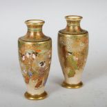 A pair of miniature Japanese Satsuma pottery vases, Meiji Period, decorated with figures walking