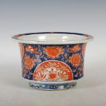 A Japanese Imari jardiniere, Meiji Period, decorated with chrysanthemum, raised on three shaped