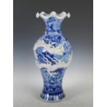 A late 19th/ early 20th century Japanese blue and white porcelain vase, decorated in relief with a