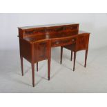 An Edwardian mahogany and boxwood lined serpentine sideboard, the upright stage back with two