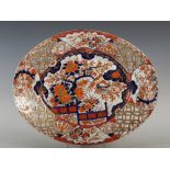 A late 19th/ early 20th century Japanese Imari oval-shaped dish, decorated with a fenced garden of