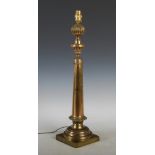 A late 19th century gilt metal table lamp, the light fitting supported on a tapered cylindrical