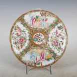 A Chinese porcelain famille rose plate, Qing Dynasty, decorated with panels of figures divided by