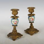 A pair of late 19th century Continental porcelain and ormolu mounted candlesticks, the foliate