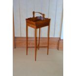 An early 20th century mahogany basket on stand, the rectangular top with gallery edge and upright