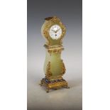 A late 19th/ early 20th century onyx, gilt metal and champleve enamel desk timepiece in the form