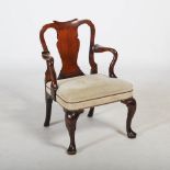 A George III mahogany elbow chair, the scroll carved top rail above a solid vase shaped splat, the
