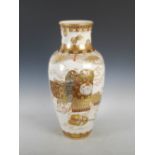 A Japanese Satsuma pottery vase, Meiji Period, decorated with a lacquer box and Samurai breast plate