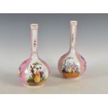 A pair of Dresden porcelain pink ground bottle vases, decorated with panels of Court figures, blue