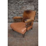 A Victorian oak armchair, with leather upholstered back and arms supported on baluster turned