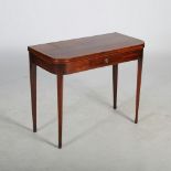 A George III mahogany and boxwood lined fold over tea table, the hinged rectangular top above a