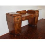 A Regency mahogany and boxwood lined twin pedestal sideboard, the centre section with two frieze