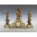 An early 20th century onyx and bronzed spelter clock garniture, the circular dial with Arabic