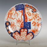 A Japanese Imari dish, late 19th/ early 20th century, with asymmetric decoration of birds and