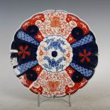 A Japanese Imari dish, late 19th/ early 20th century, decorated with a central roundel within a