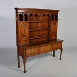 An antique oak dresser, the later moulded cornice and dentil frieze above three open shelves flanked